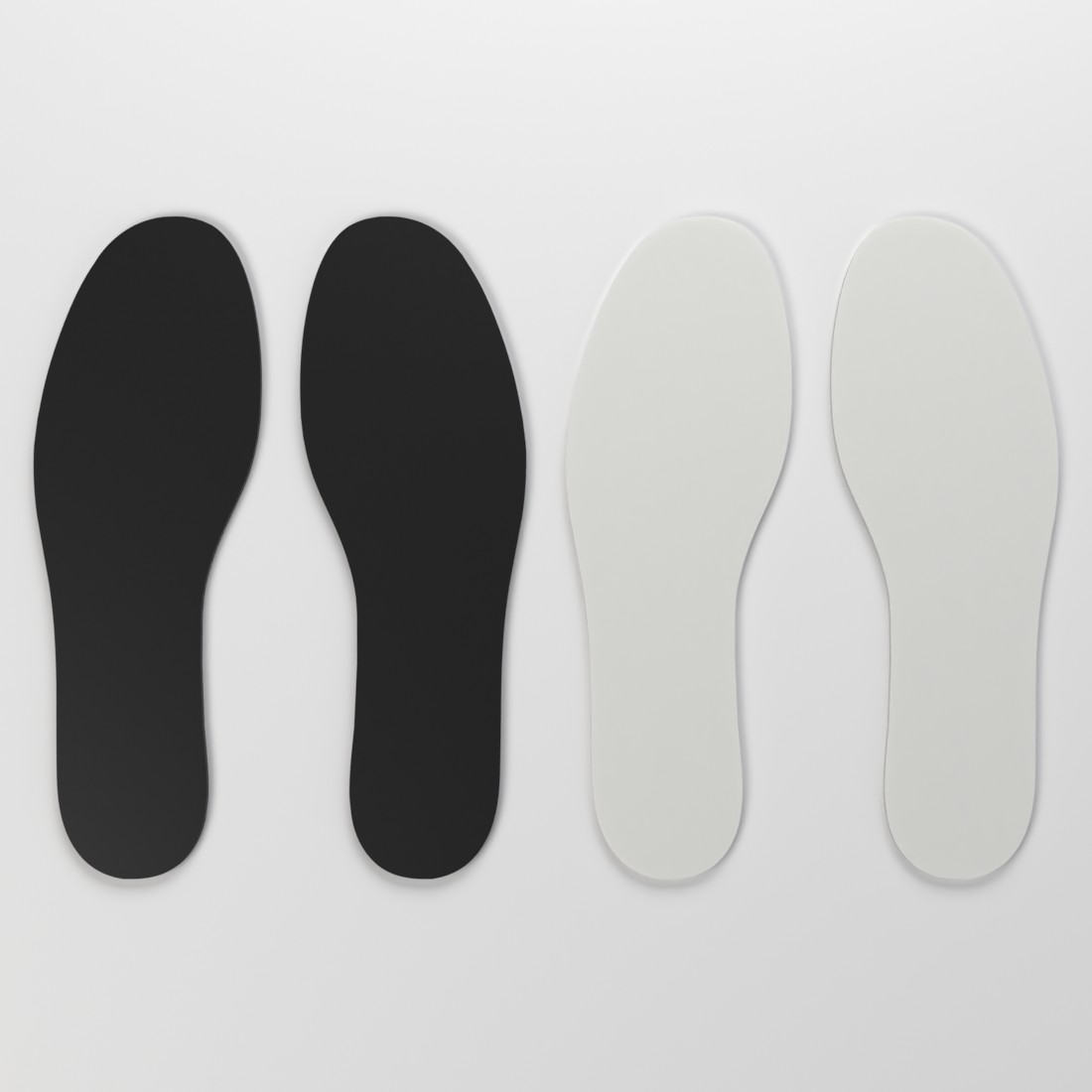 Black and white ski boot volume reducer pairs shown from above