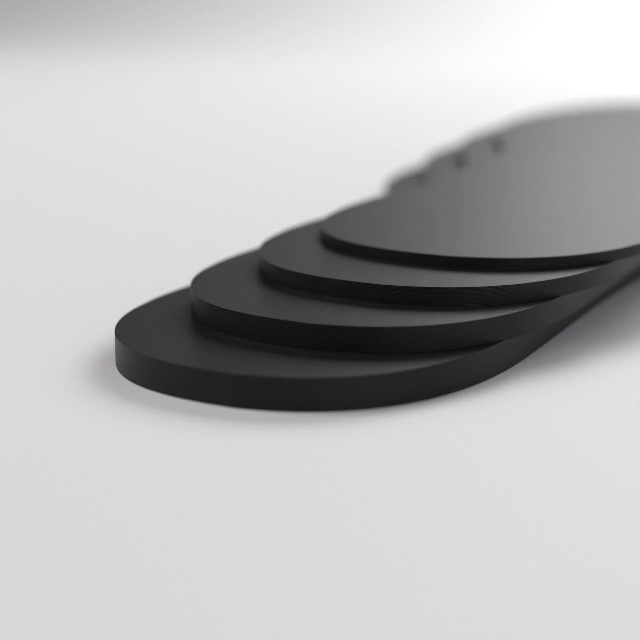 Black volume reducers stacked to show 2mm, 3mm, 4mm and 5mm thicknesses