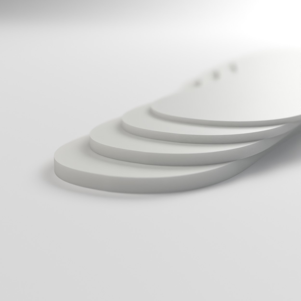 White volume reducers stacked to show 2mm, 3mm, 4mm and 5mm thicknesses